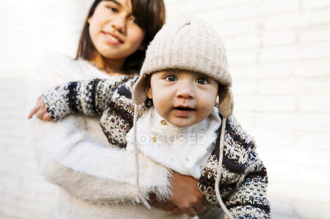Cropped portrait of smiling girl holding baby boy — Stock Photo