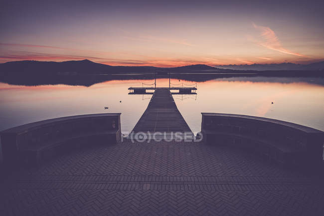 View of wooden pier against water at dawn — Stock Photo
