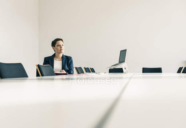 Porträt einer reifen Geschäftsfrau am Konferenztisch — Stockfoto