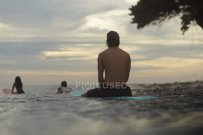 Indonesia, Java, surfers on surfboards in ocean waiting for a wave — Stock Photo