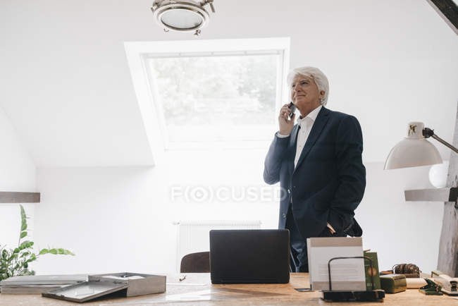 Senior businessman on the phone in office — Stock Photo