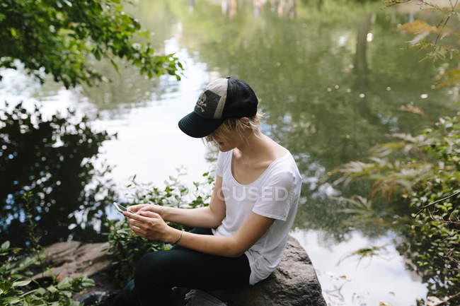 Junge Frau schreibt SMS auf Handy im Central Park, Manhattan, New York — Stockfoto