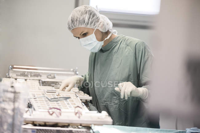 Операційний зал медсестра шукає інструмент — стокове фото
