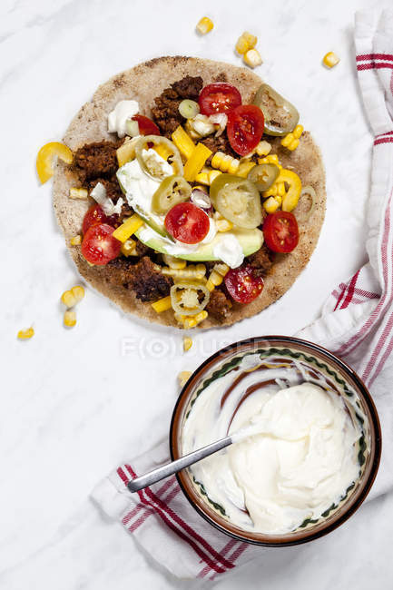 Top view of Mexican Tortilla with mincemeat, avocado, tomatoes and corn — Stock Photo