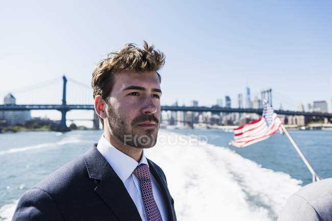 Businessman standing on ferry on East River, New York City, USA — Stock Photo
