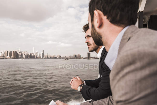 Two businessmen on ferry on East River, New York City, USA — Stock Photo