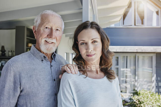 Caucasian father and grown up daughter, portrait — reflexion, standing