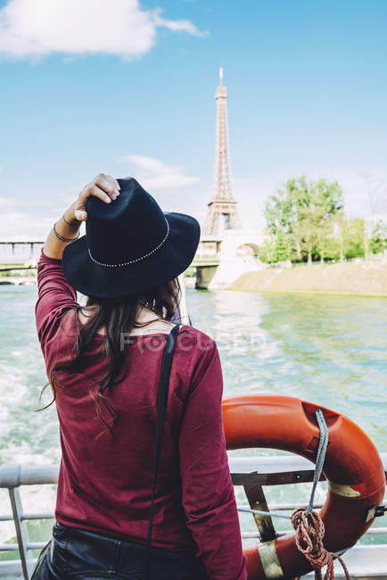 France, Paris, back view of woman on tour boat looking at Eiffel Tower — Stock Photo