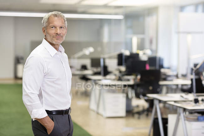 Businessman standing in office — Stock Photo