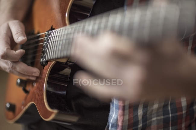 Close Up Of Man Playing Electric Guitar Caucasian Part Of Stock Photo