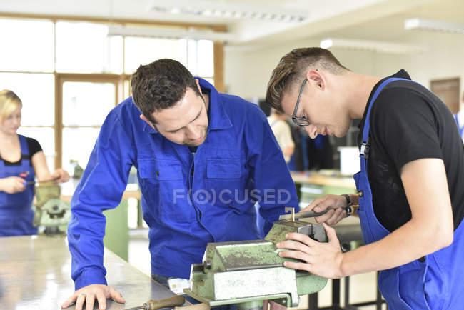Instrutor com estagiário na bancada — Fotografia de Stock