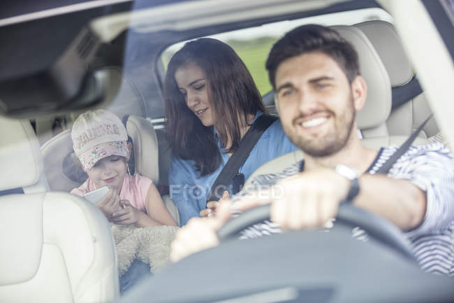 Happy family on road trip in car — Stock Photo
