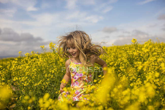 Loira menina correndo no campo de estupro — Fotografia de Stock