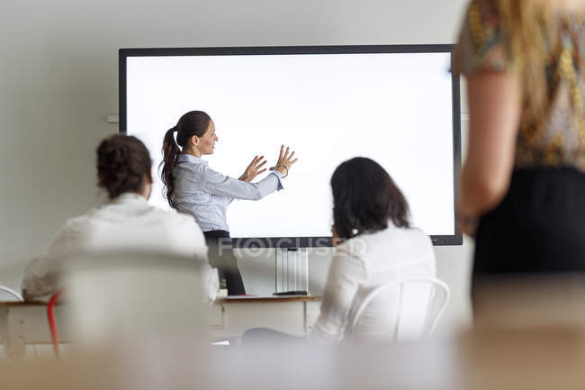 Businesswoman leading a presentation in modern office — Stock Photo