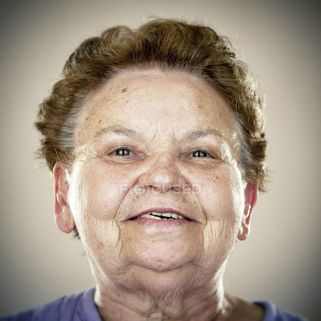 Portrait of smiling senior woman looking at camera — experience, brown ...