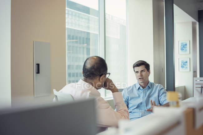 Due uomini d'affari che parlano insieme in ufficio — Foto stock