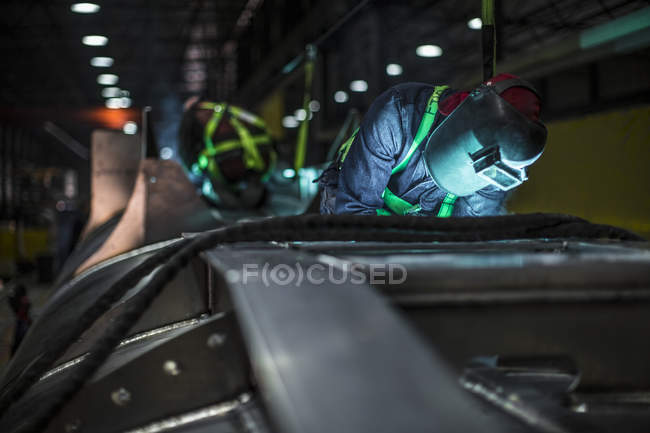 Man welding steel in factory — Stock Photo