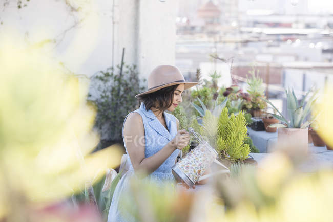 Young woman on rooftop gardening, Los Angeles, USA — Stock Photo