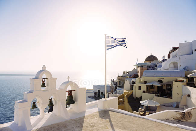 Greek flag waving on a church — Stock Photo
