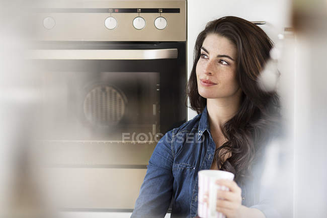 Young woman with cup of coffee — Stock Photo