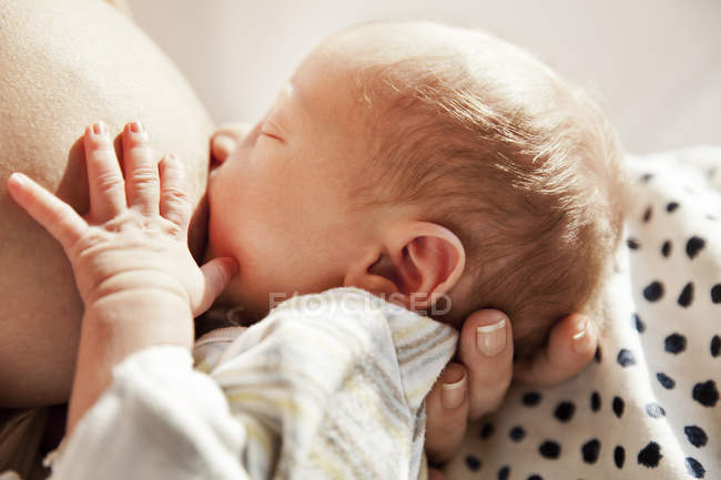 Close-up of baby being breast-fed by his mother — Stock Photo