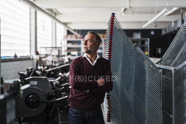 Mature man in a printing shop — Stock Photo