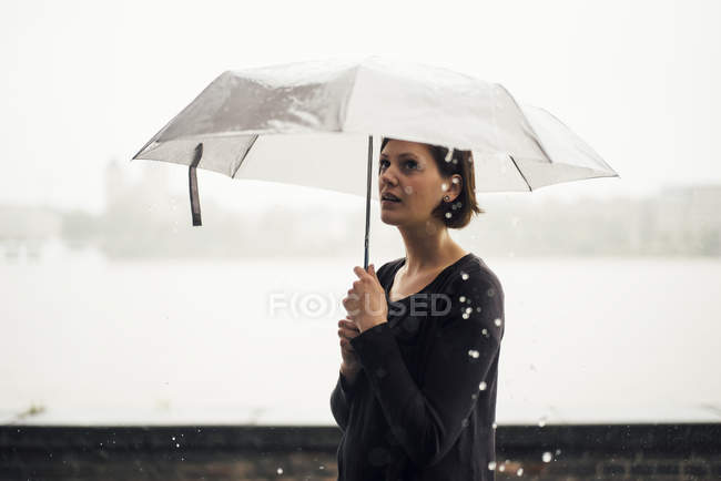 Woman with umbrella on a rainy day — Stock Photo