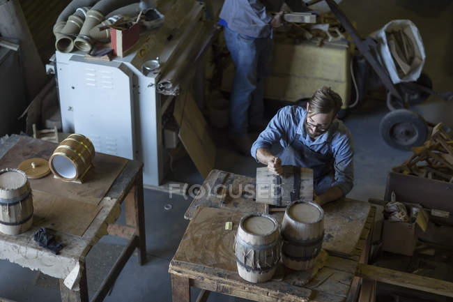 Cooper making wine barrels in workshop — Stock Photo