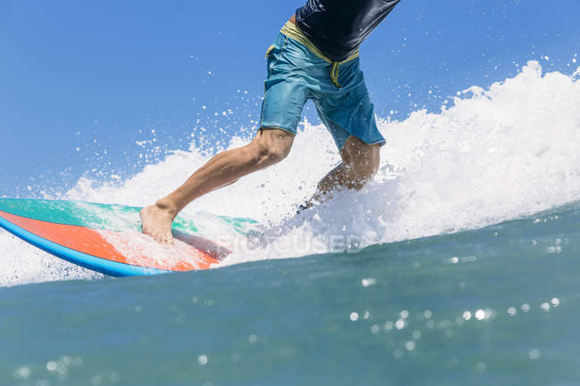 Indonesia, Bali, surfer standing on surfboard — Stock Photo