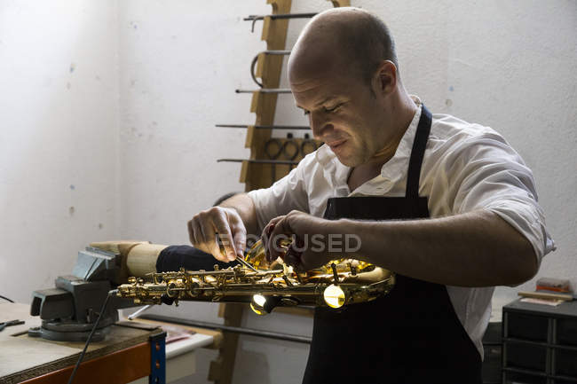 Instrument maker working in his workshop — Stock Photo