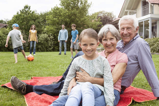 Portrait of happy extended family in garden — Stock Photo