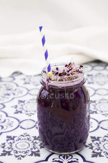 Glass of red cabbage smoothie with beetroot sprouts — Stock Photo