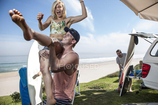 Man lifting up excited woman — Stock Photo