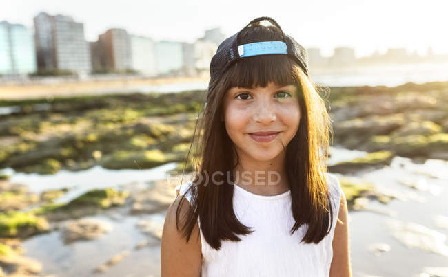Porträt eines lächelnden Mädchens am Strand bei Sonnenuntergang — Stockfoto
