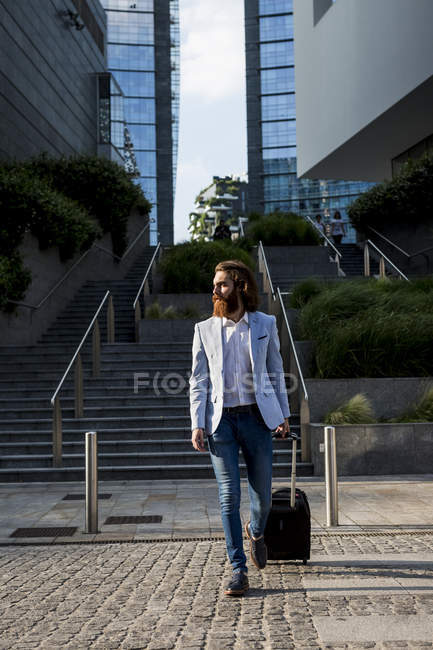 Businessman walking with suitcase — Stock Photo