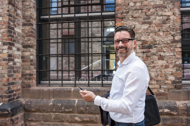 Businessman with cell phone — Stock Photo