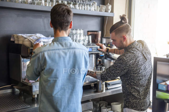 Dos hombres preparando café en un café - foto de stock