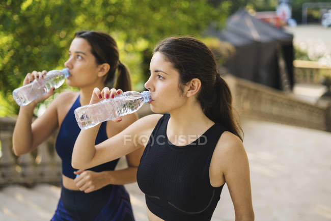 Young Fitness Women With Water Bottles Focus On The Bottles Stock