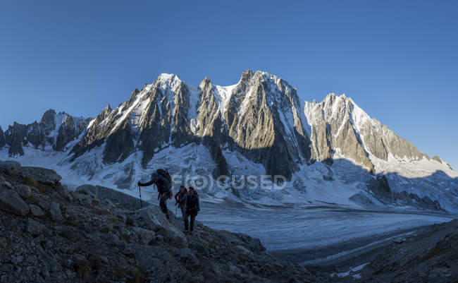 France, Chamonix, Argentiere Glacier, Les Droites, Les Courtes, Aiguille Verte, group of mountaineers trekking in alps — Stock Photo