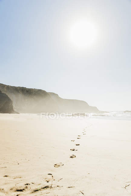 Portugal, Alentejo, Rocks and footprints at Zambujeira do Mar beach — Stock Photo