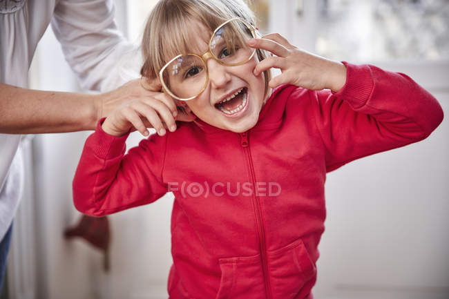 Portrait of playful girl wearing oversized glasses — Stock Photo