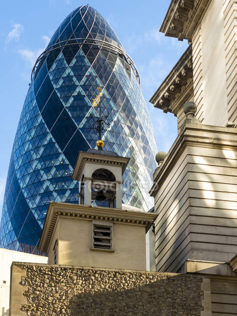 UK, London, City of London, view to 30 St Mary Axe and St Andrew Undershaft in the foreground — Stock Photo