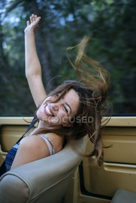 Mulher feliz sentada em encoberto — Fotografia de Stock