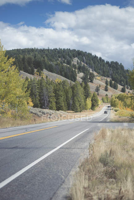 USA, Wyoming, Grand Teton National Park, Oxbow Bend Turnout Road with car on background — Stock Photo