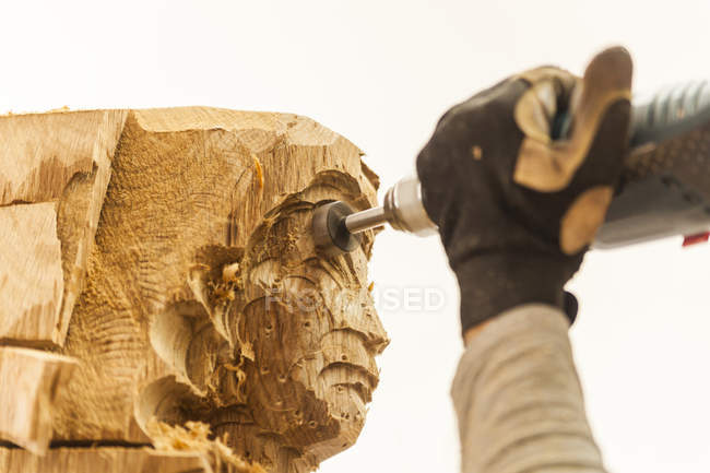 Holzschnitzer in der Werkstatt arbeitet mit Fräsmaschine an Skulptur — Stockfoto
