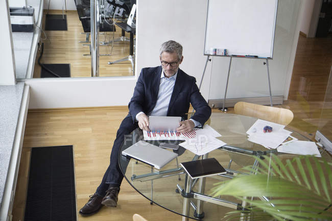 Успешный бизнесмен сидит в бортовой комнате с помощью цифрового планшета — стоковое фото