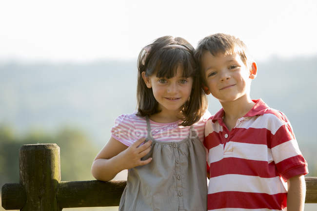 Happy Little Boy And Girl Standing Face To Face In Nature Harmony Smiling Stock Photo