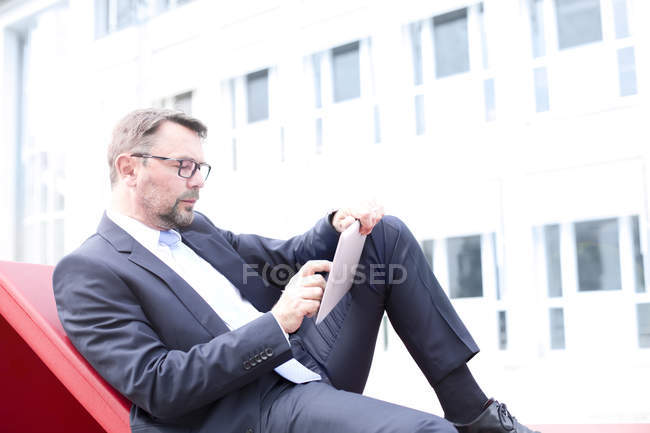 Businessman using digital tablet — Stock Photo