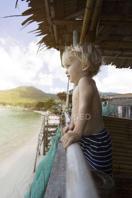 Thailand, toddler in a in beach hut looking at distance — Stock Photo