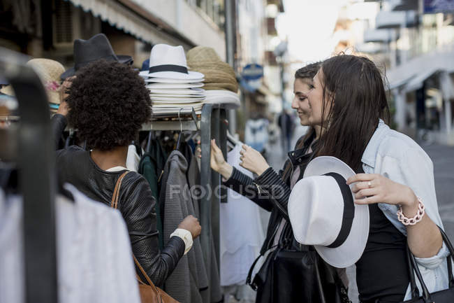Young women shopping for clothes in the city — Stock Photo
